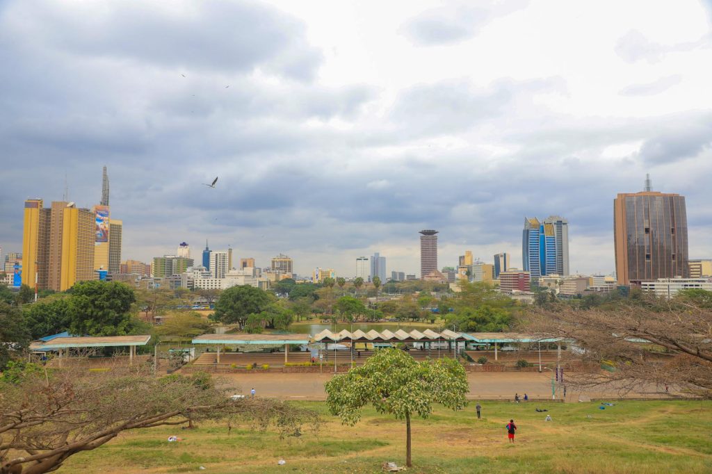 Movers in blue uniforms carrying a desk during an office relocation in Nairobi CBD.