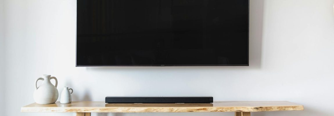A professional installing a TV wall mount in a modern Nairobi living room.
