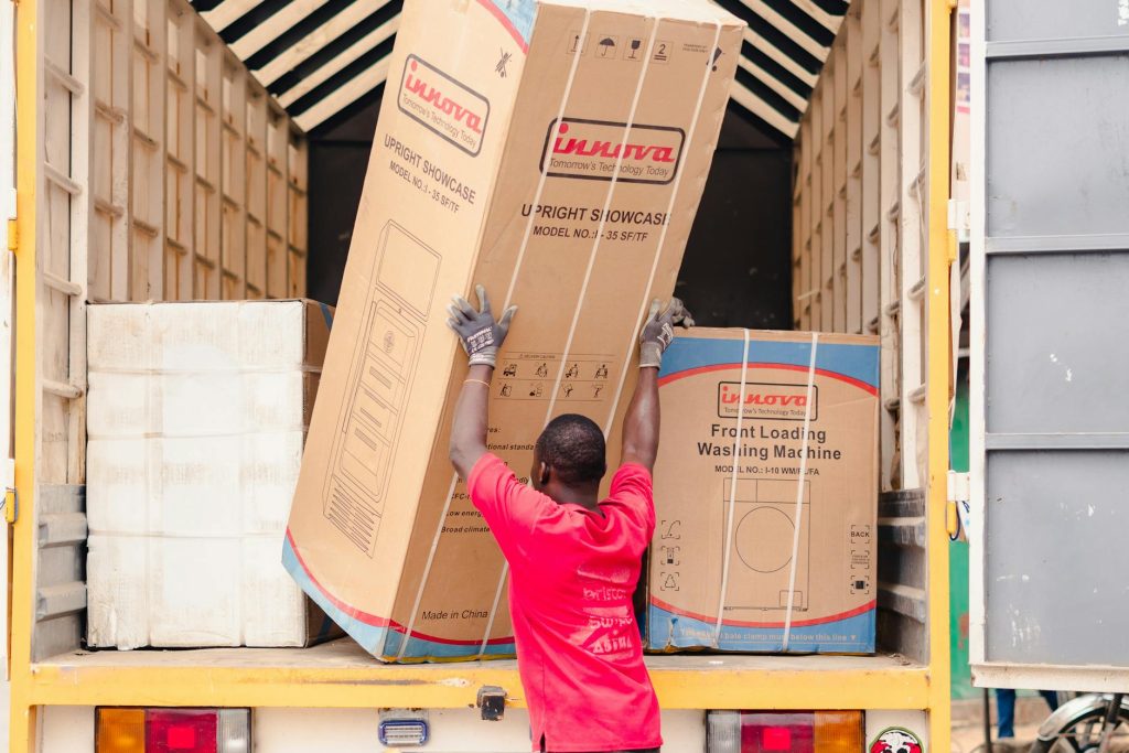 Professional movers loading furniture into a moving truck in Westlands.
